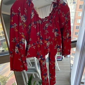 Red off the shoulder cropped blouse with flower pattern. Size M.